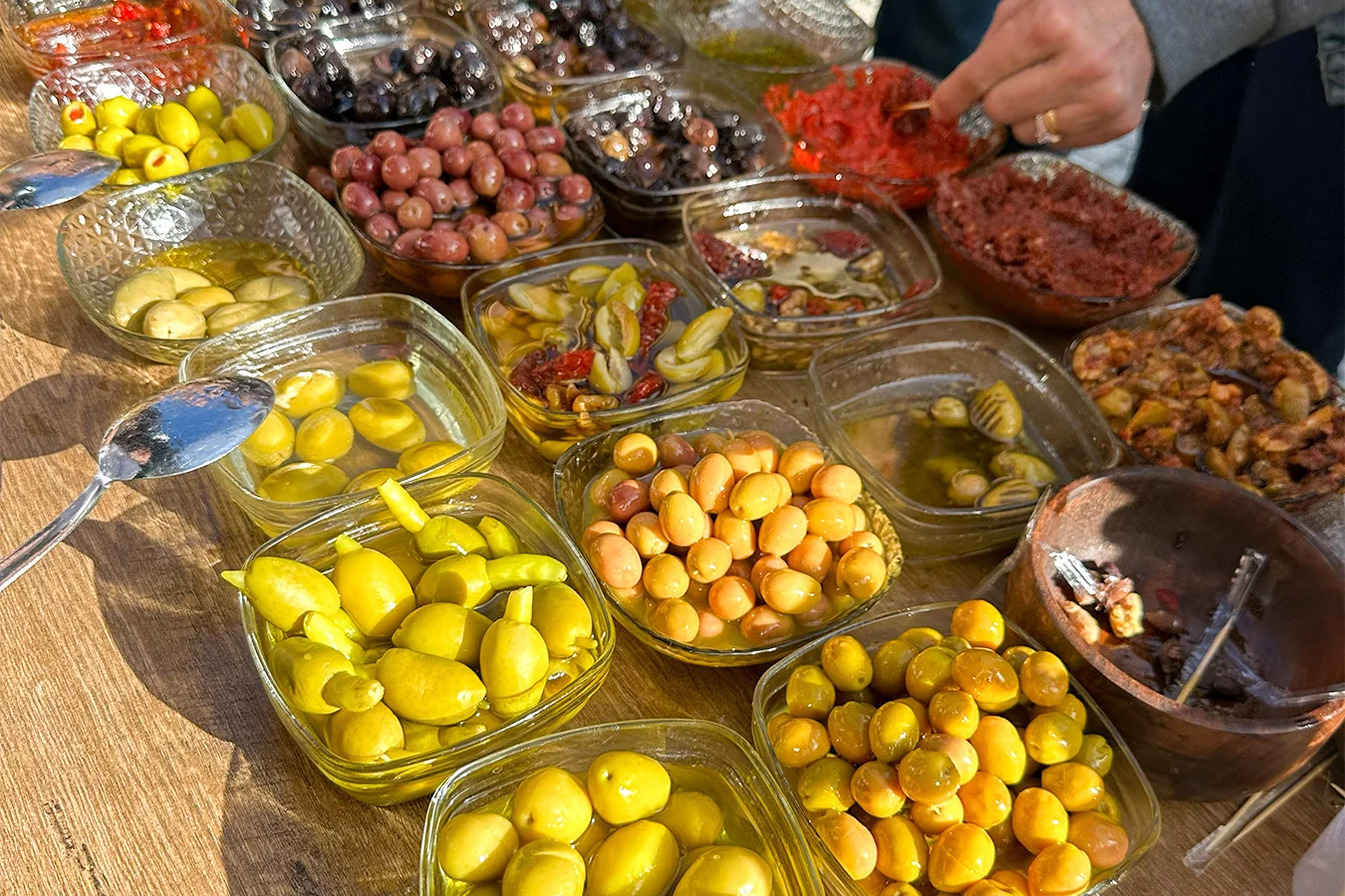Tadım masasında kaselerde yeşil, siyah ve dolgulu zeytinler